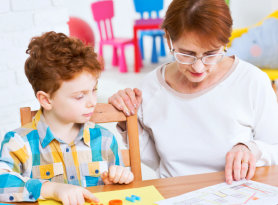 elderly woman teaching little bot